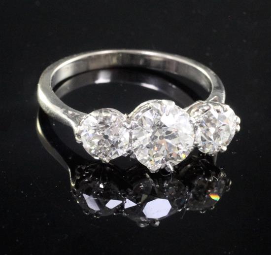 A mid 20th century platinum? and three stone diamond ring, size O.